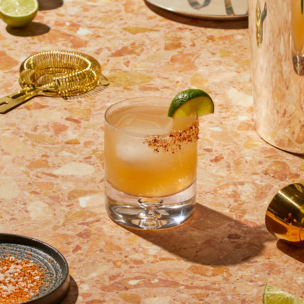 Nowadays Pucker Up Cannabis Drink with lime on textured counter top